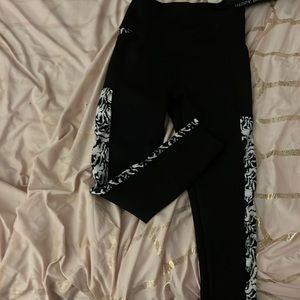 black athletic leggings with blue and white marble design on the side